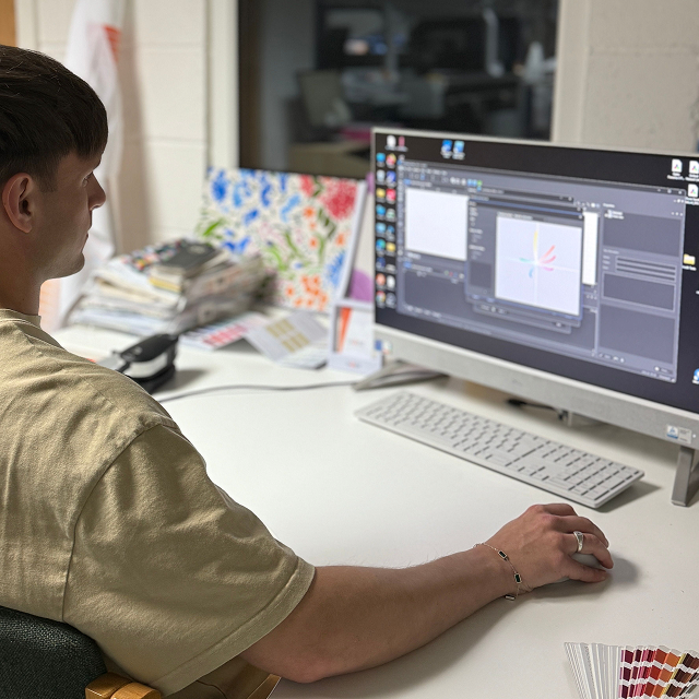 Cadworks textile printe specialist at work on a computer